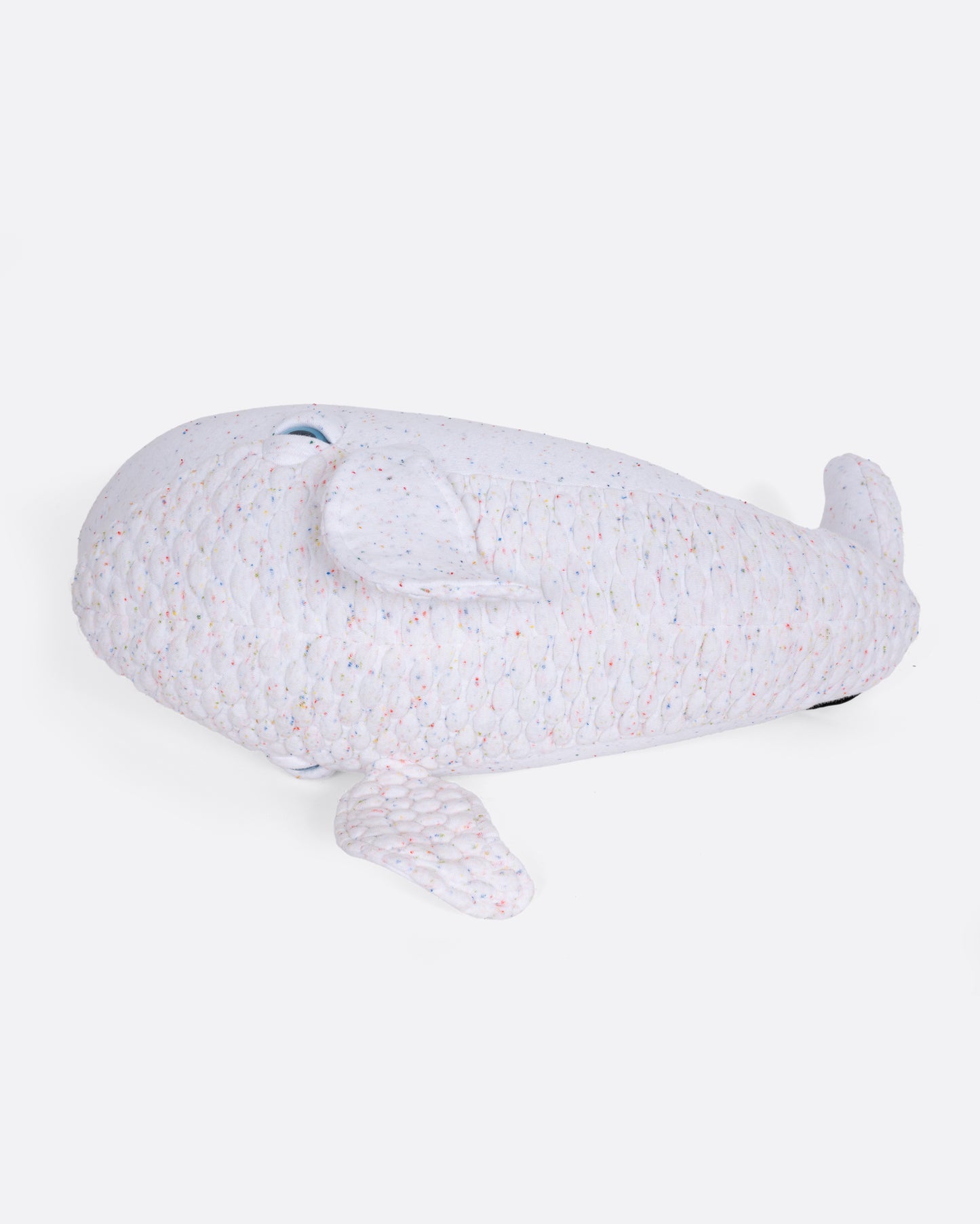 A confetti speckles white beluga whale stuffed animal shown from underneath.