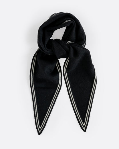 A cashmere black neck scarf with stripy white edges, shown tied from the front.