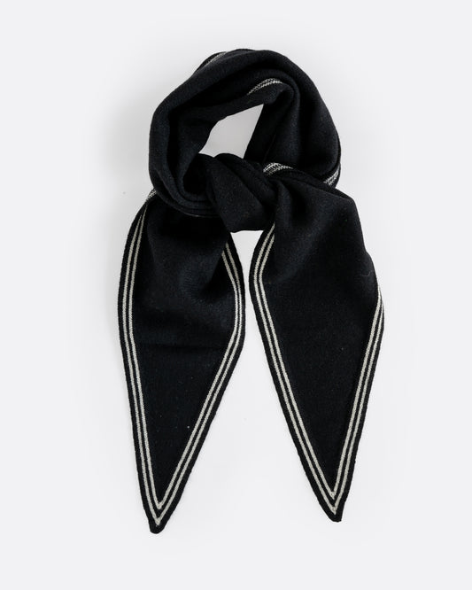 A cashmere black neck scarf with stripy white edges, shown tied from the front.
