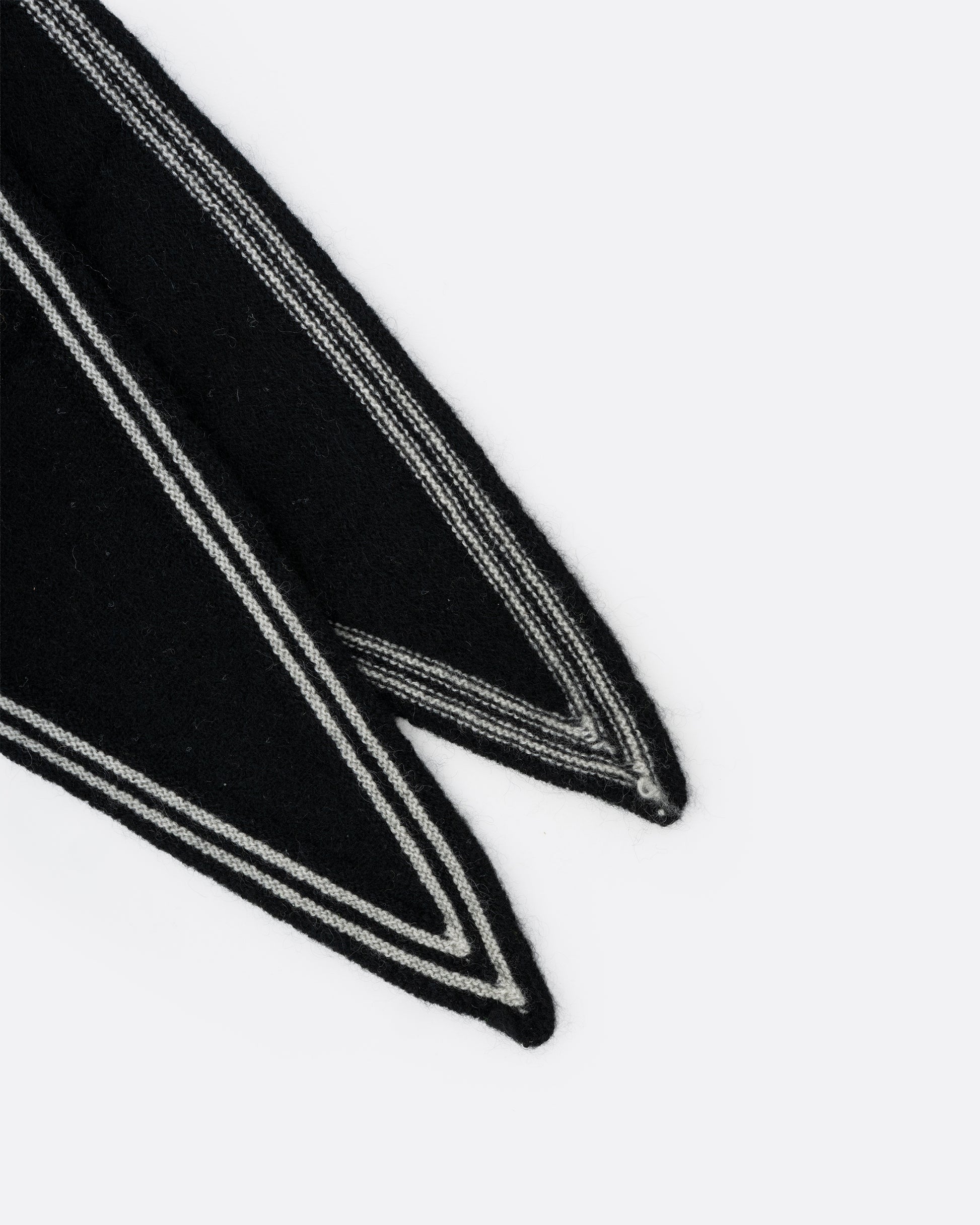 A close up of a cashmere black neck scarf with stripy white edges.