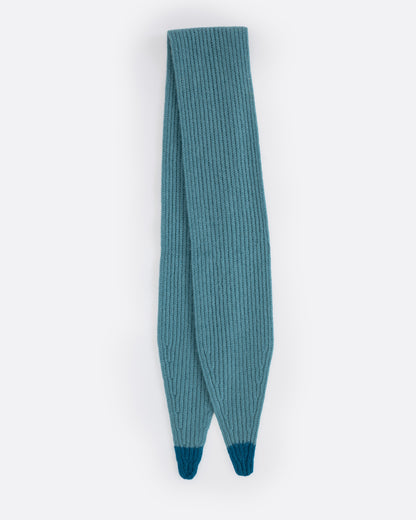 A teal cashmere scarf with blue tips, shown folded in half.