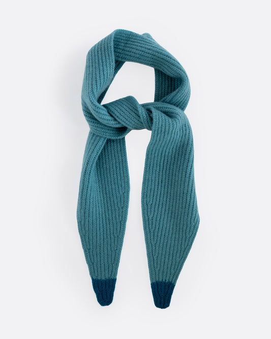 A teal cashmere scarf with blue tips, shown tied from the front.
