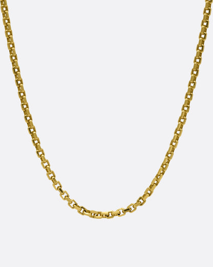 A yellow gold square link necklace, shown from the front.