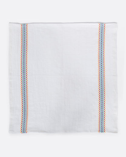 White linen napkin with multicolor stripe laid flat