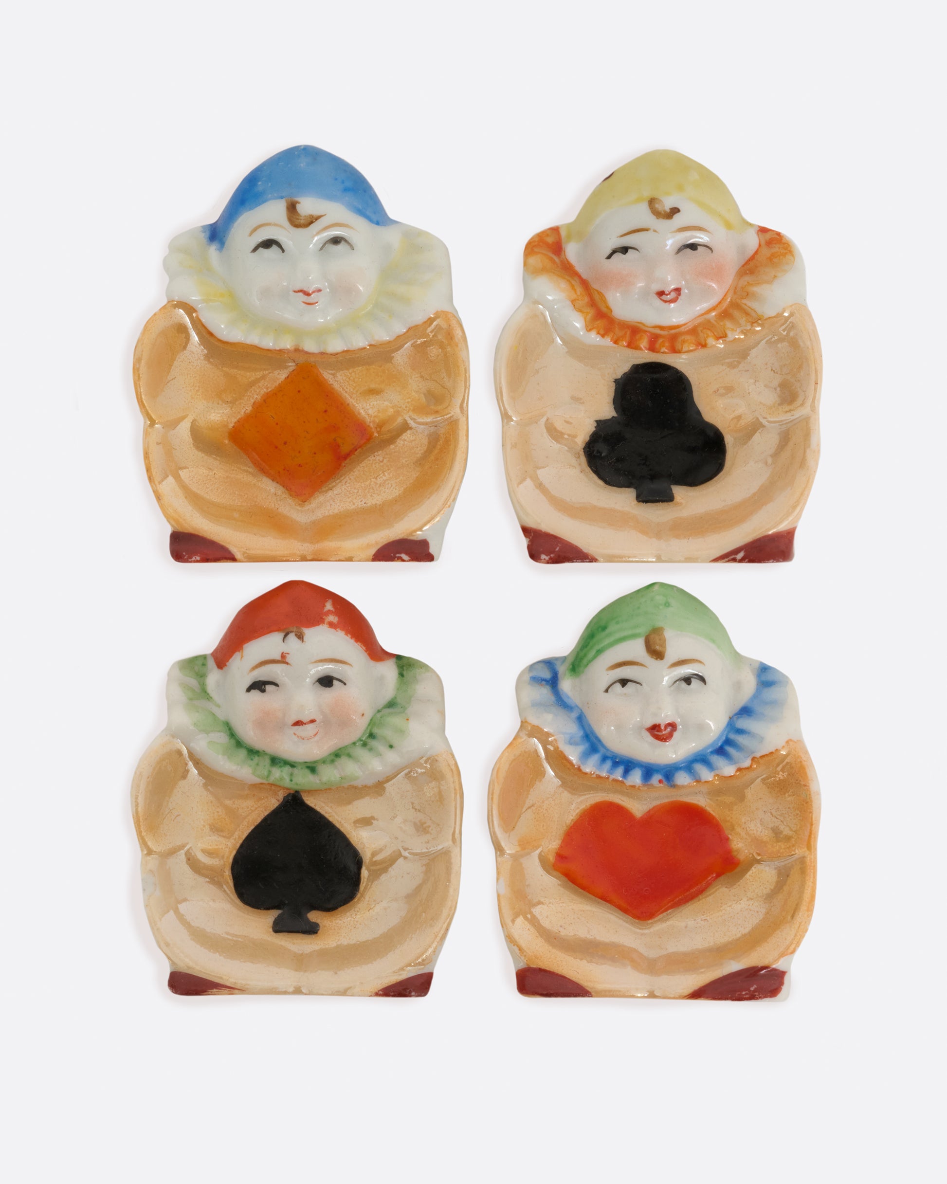 A set of 1940's Japanese harlequin clown dishes with card suit costumes. Shown from the top.