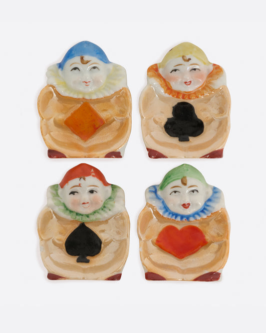 A set of 1940's Japanese harlequin clown dishes with card suit costumes. Shown from the top.