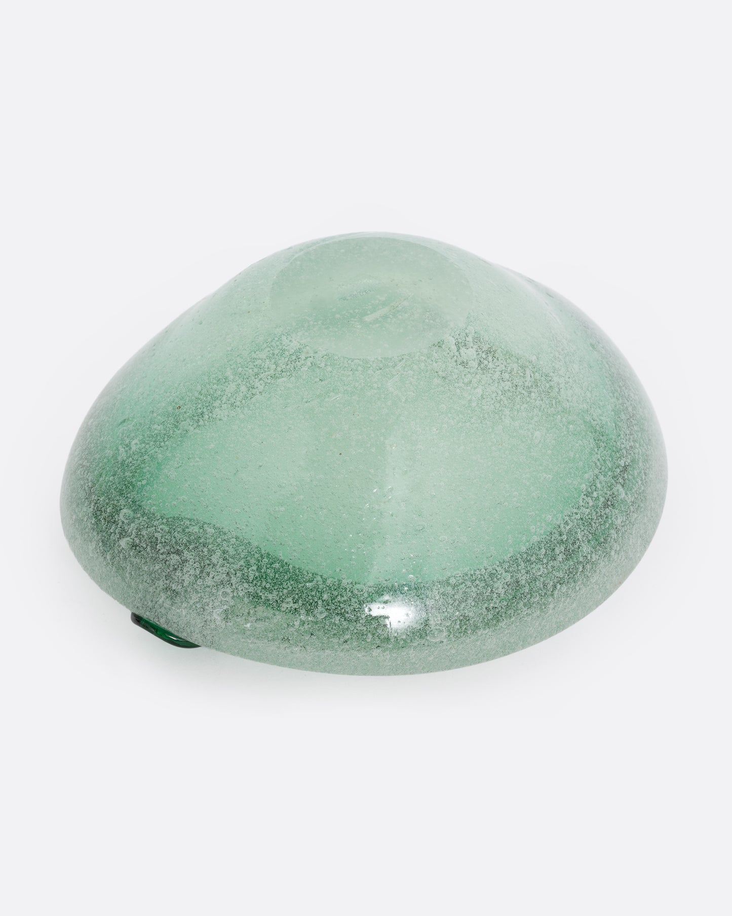 A green blown glass ashtray, shown from the bottom.