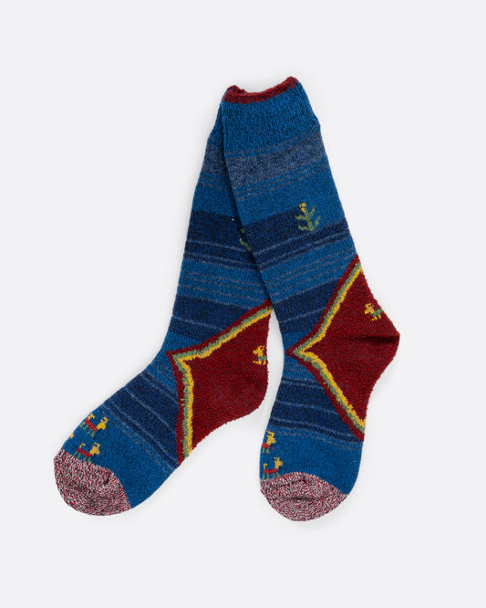 Striped blue knit socks with a red heel and small floral details. View laying flat.