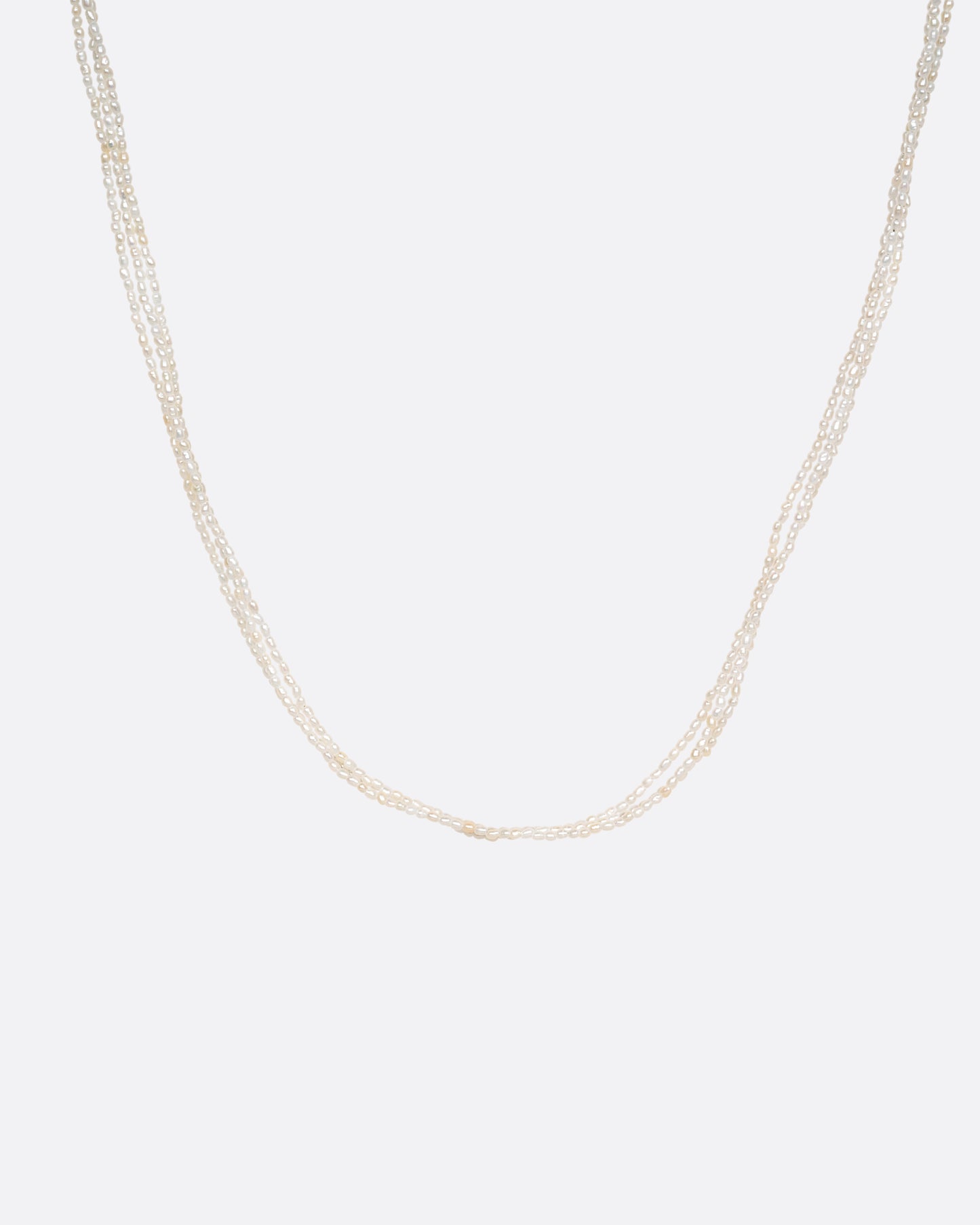 A three strand pearl necklace, shown from the front.