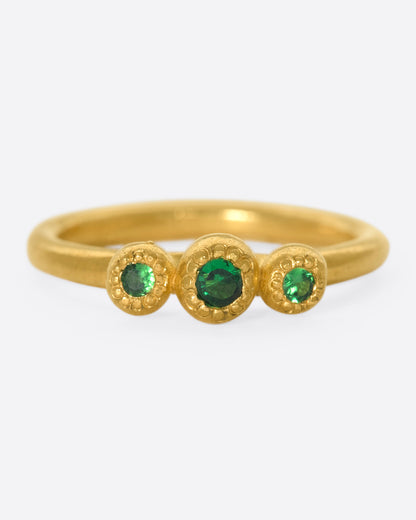 Oraik Little Pleasures ring in 22k yellow gold, three green tsavorite garnets in beaded gold bezels on a slim band