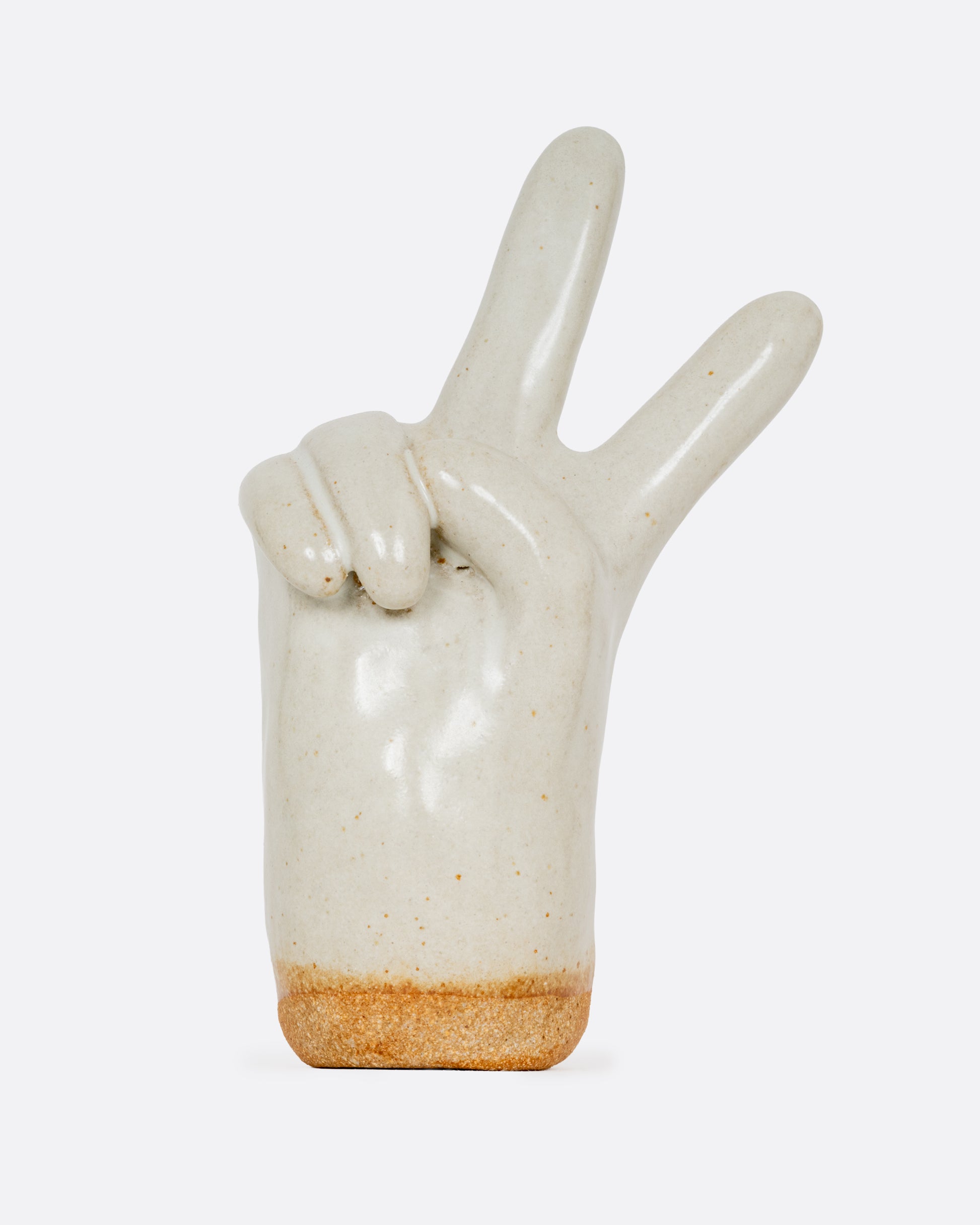 A stoneware white hand making the peace sign glazed in speckled white. Shown from the front.