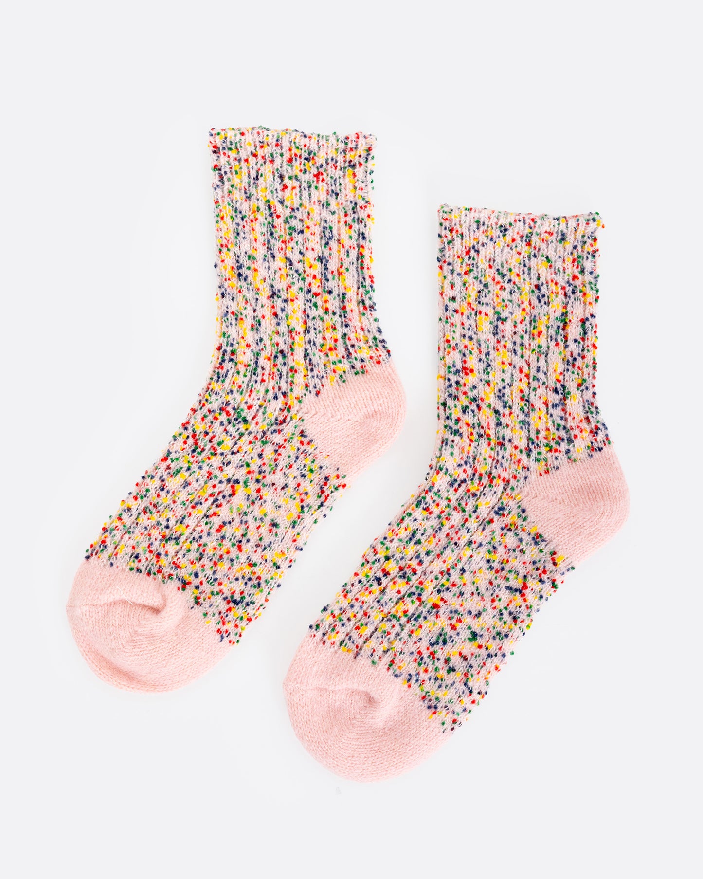 A pair of pink crew socks with colorful confetti yarns, shown from the side.
