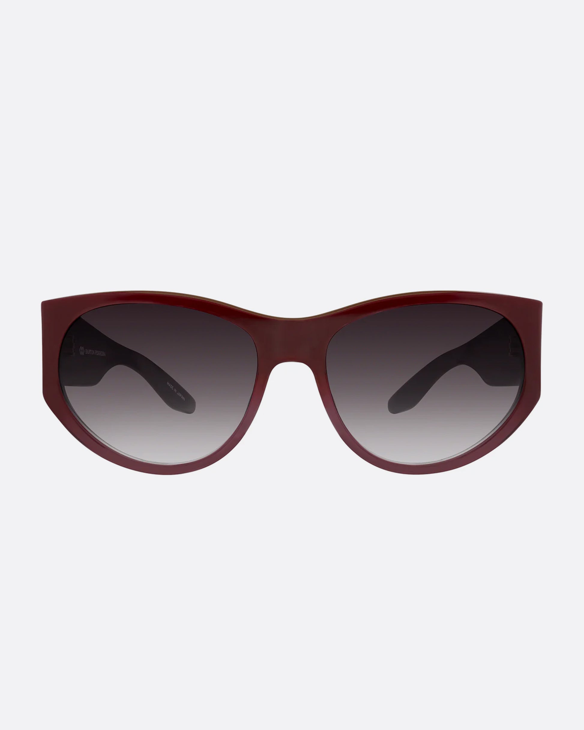 A pair of burgundy sunglasses with gradient lenses. Shown from the front.