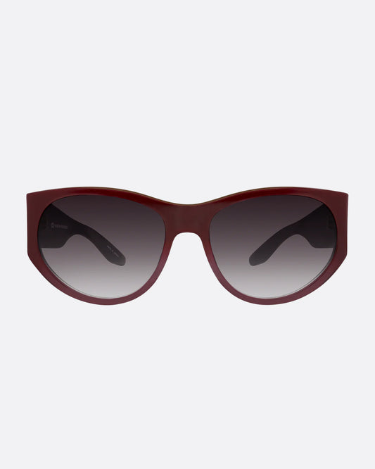 A pair of burgundy sunglasses with gradient lenses. Shown from the front.