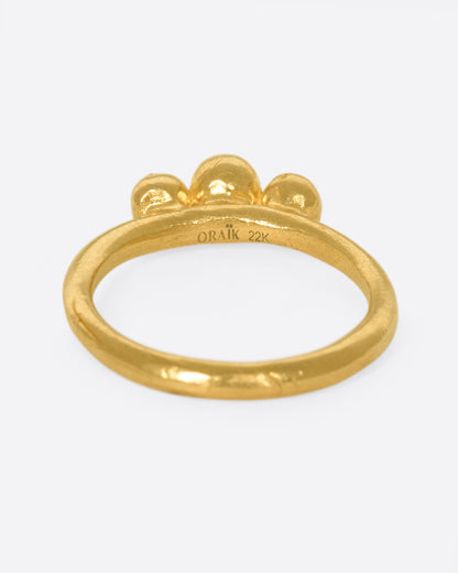 Yellow gold green garnet three stone ring, back view of the band showing the Oraik and 22k stamps