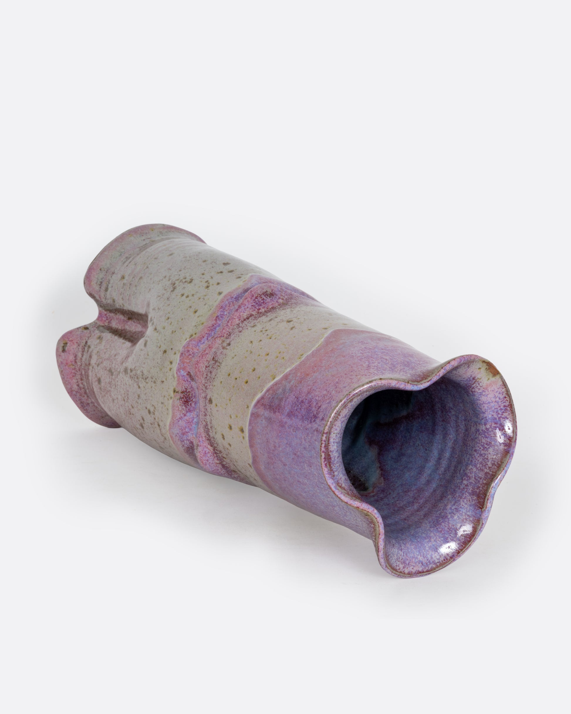 A tall ceramic vase with a tiered silhouette, fluted top, and gray and lavender color scheme. Shown lying on its side from the side.