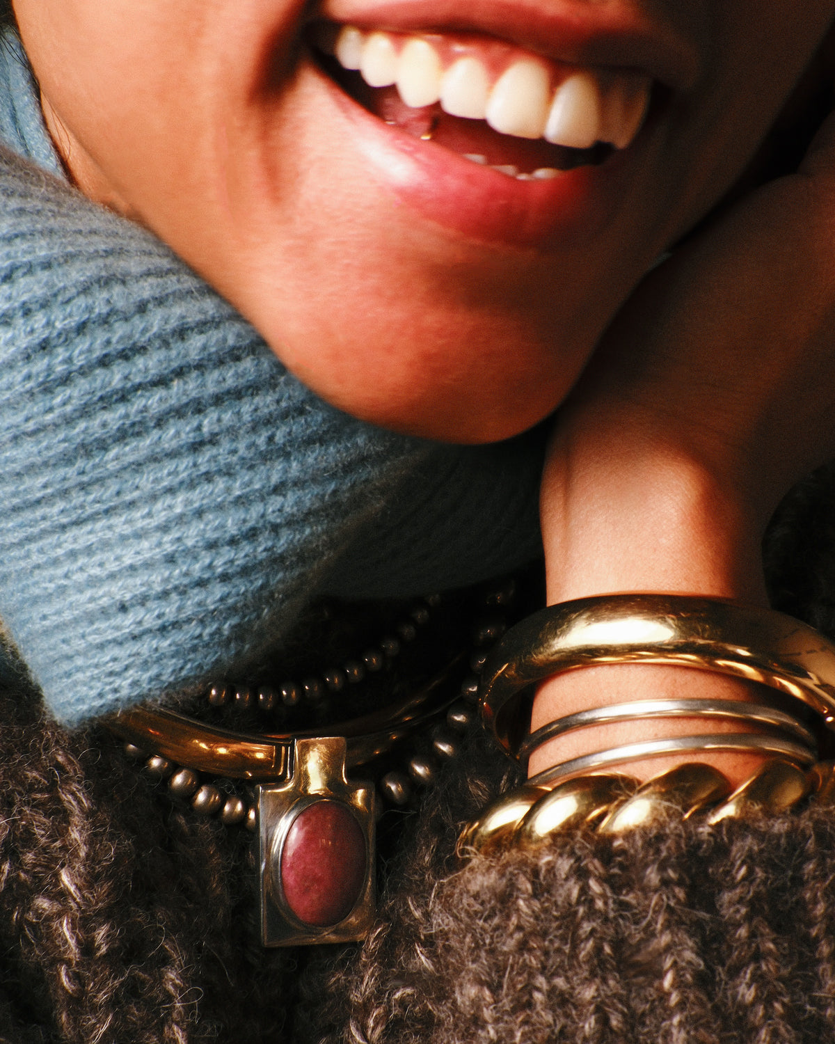 Vintage silver graduated bead necklace worn layered with gold necklaces and stacked bangles