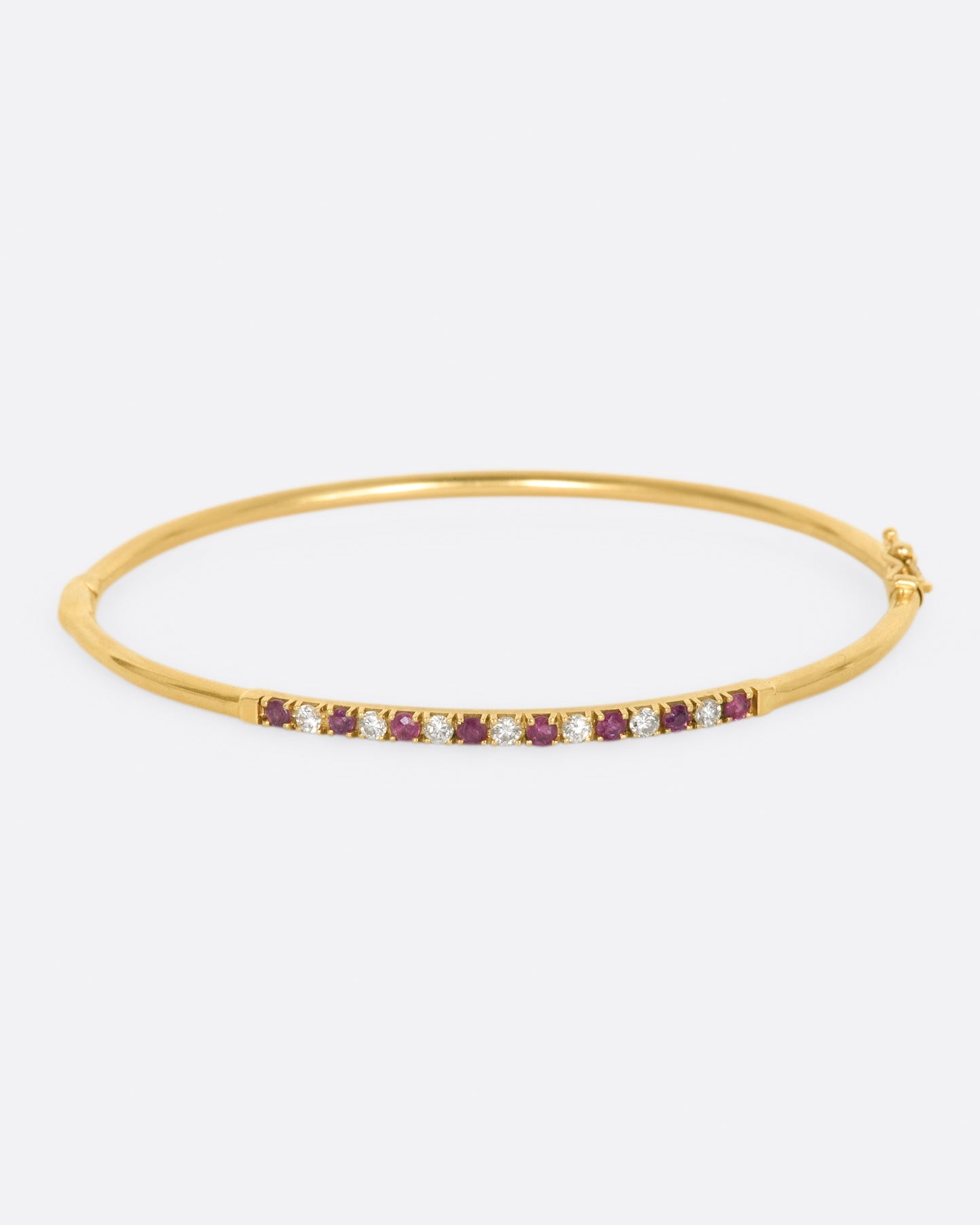 Yellow gold bracelet with alternating rubies and diamonds. View from the front.