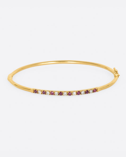 Yellow gold bracelet with alternating rubies and diamonds. View from the front.