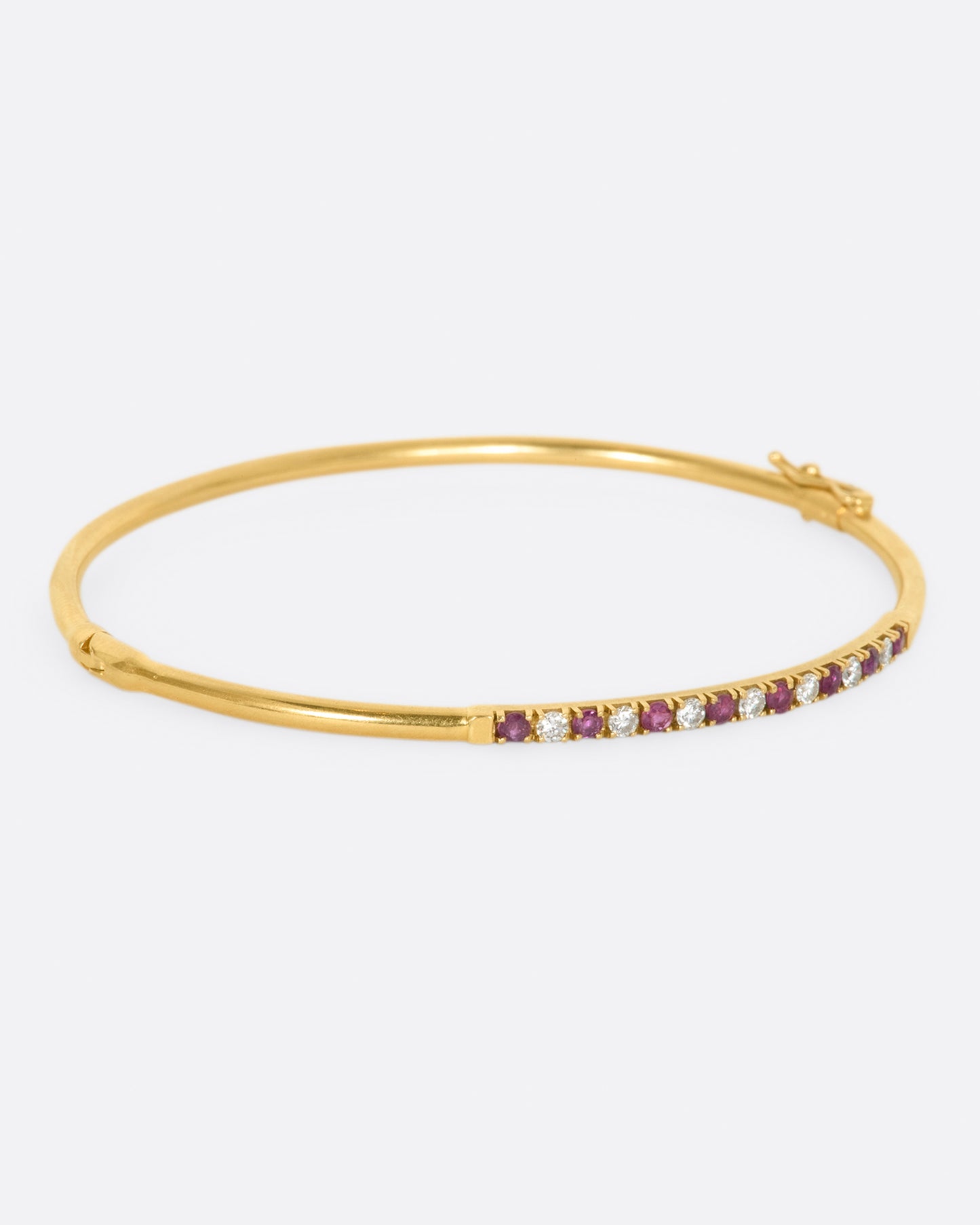 Yellow gold bracelet with alternating rubies and diamonds. View from the right side.