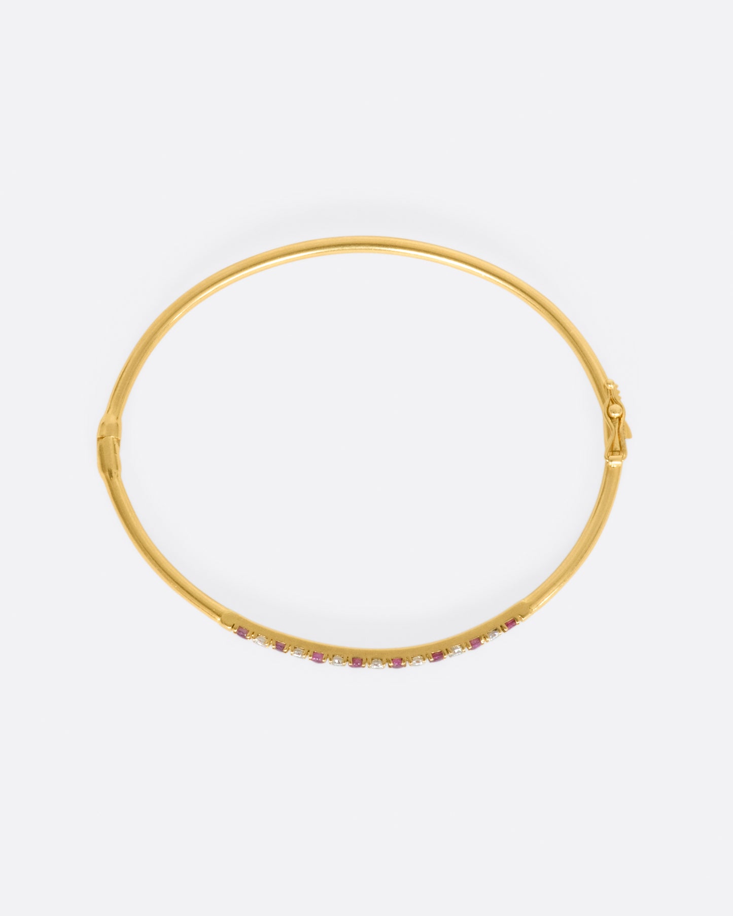 Yellow gold bracelet with alternating rubies and diamonds. View from above.