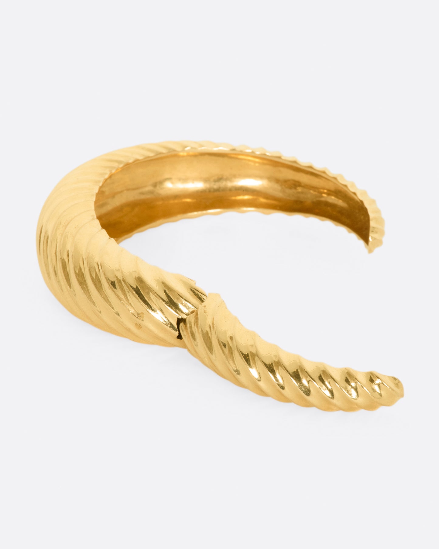 Yellow gold cuff with ridges that create a twisted look. View opened.