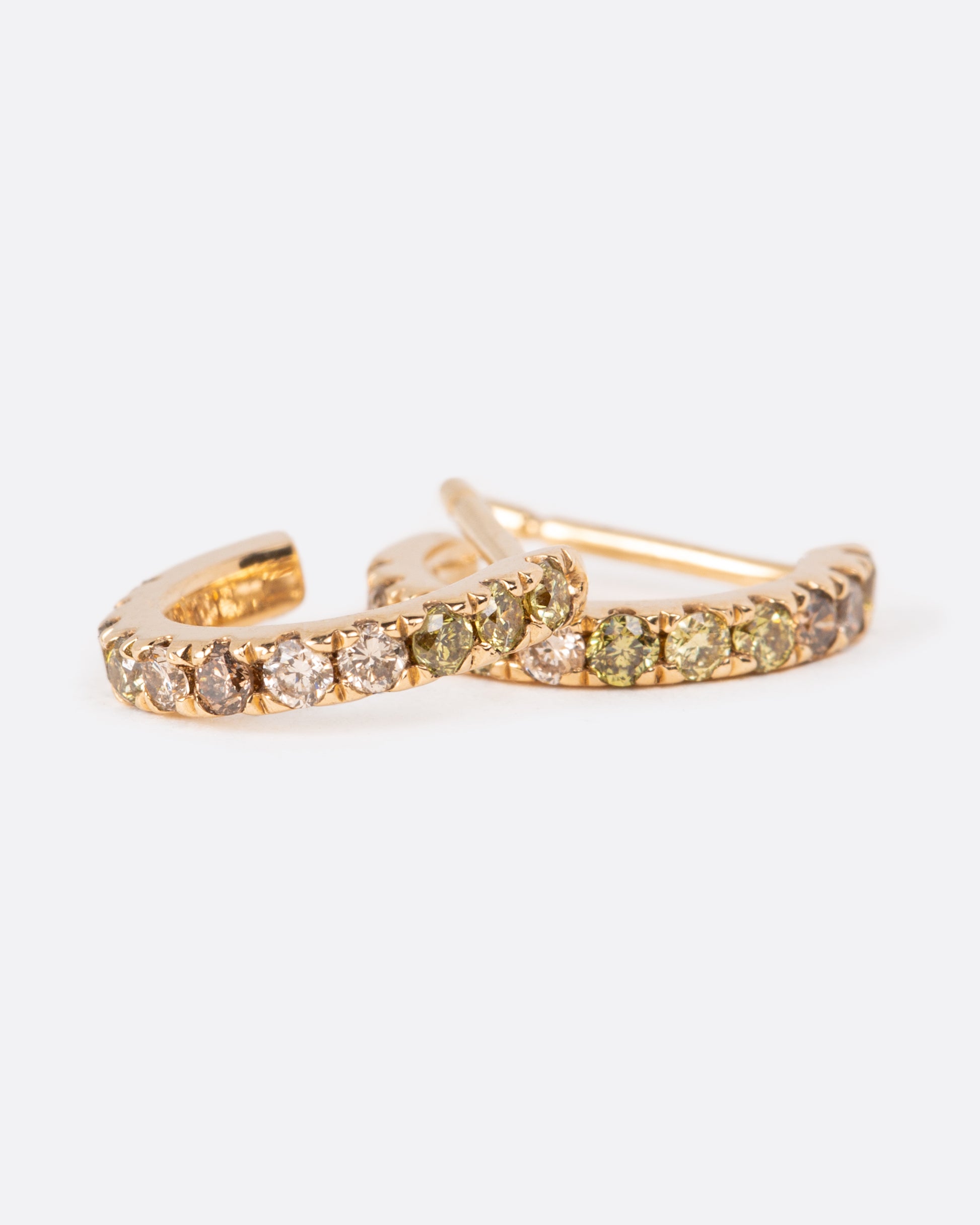 A pair of yellow gold hoops lined with shades of olive, champagne and cognac diamonds.