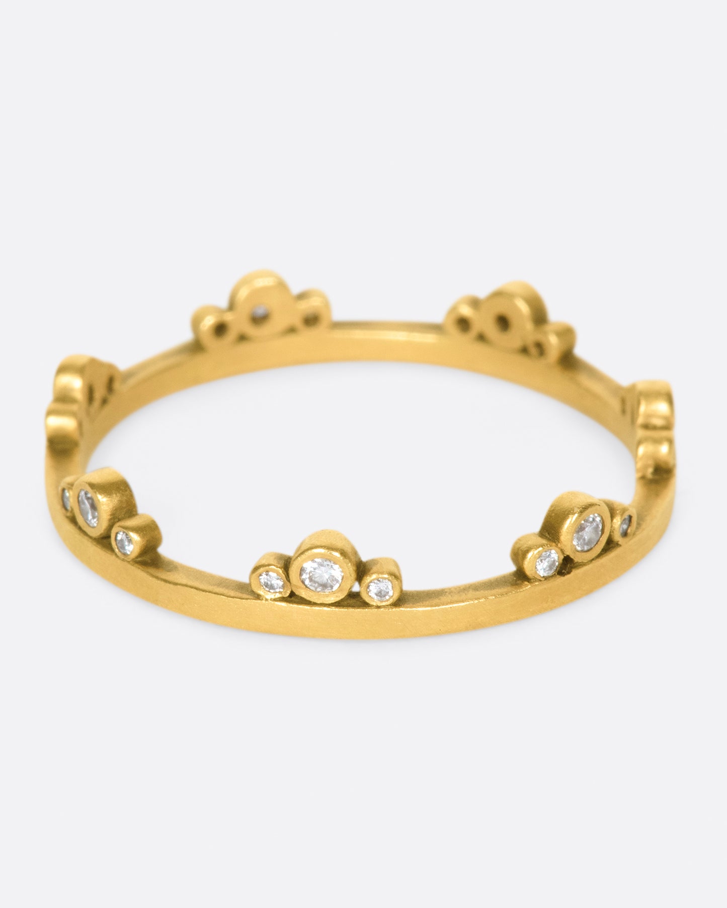 A matte gold band crowned with seven trios of diamonds.