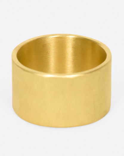 A wide, matte yellow gold hammered band with a rose cut gray diamond, shown from the back.