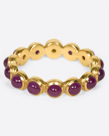 Yellow gold ruby band with moon face, back view of the ring with rubies along the front edge