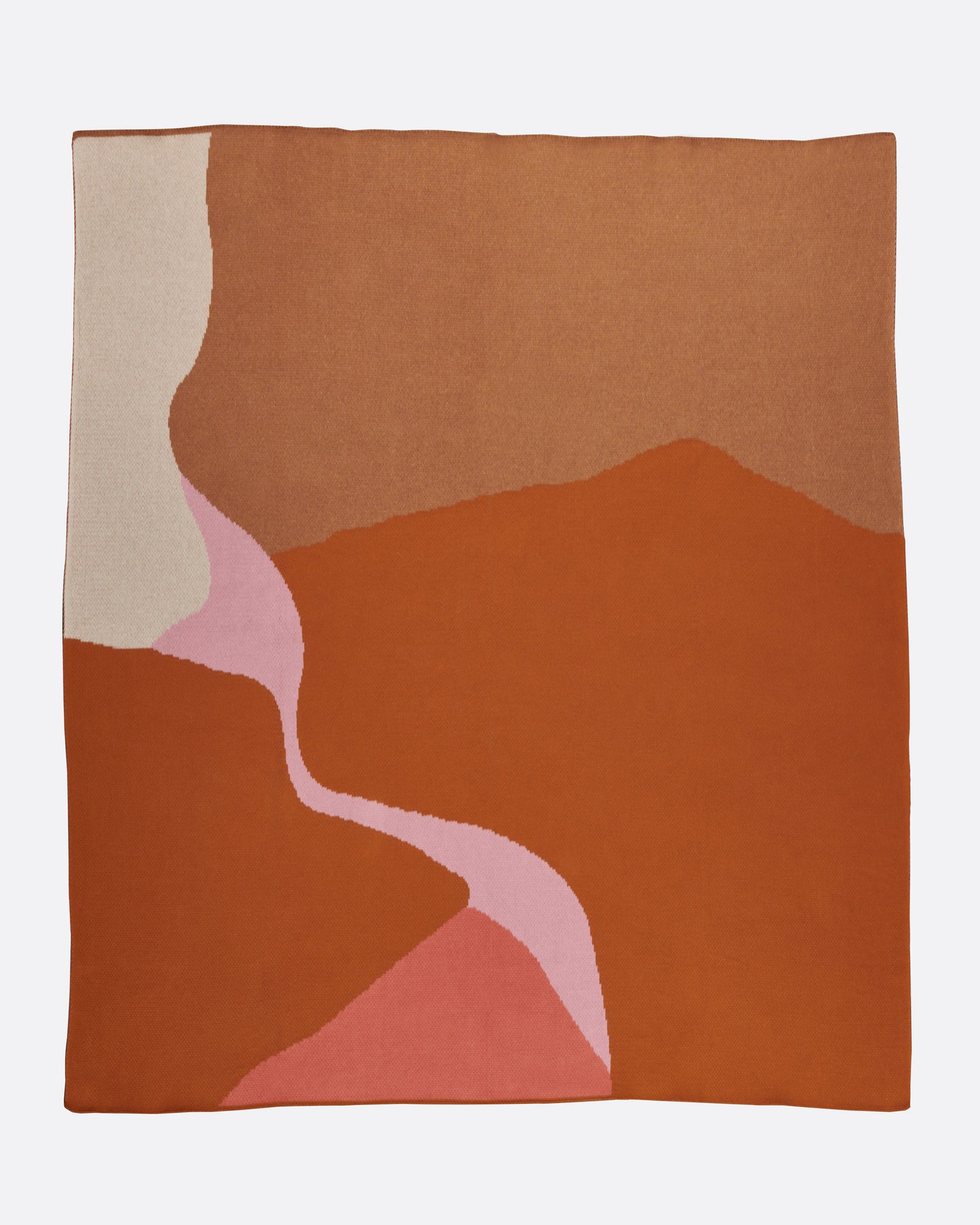 A long knit jacquard throw blanket featuring a minimalist design inspired by the Mojave desert, shown from above.