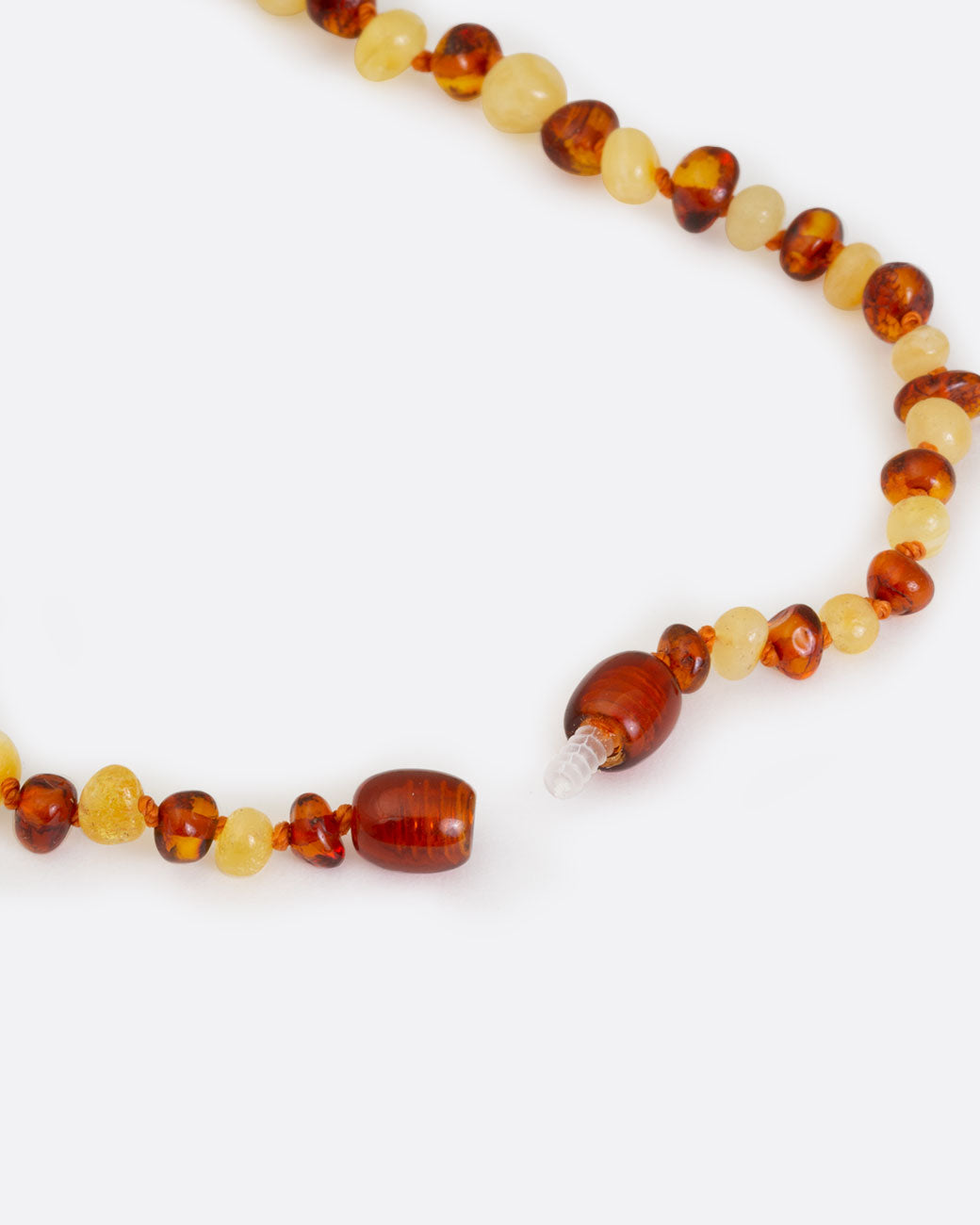 Multicolor amber teething necklace, shown unclasped.