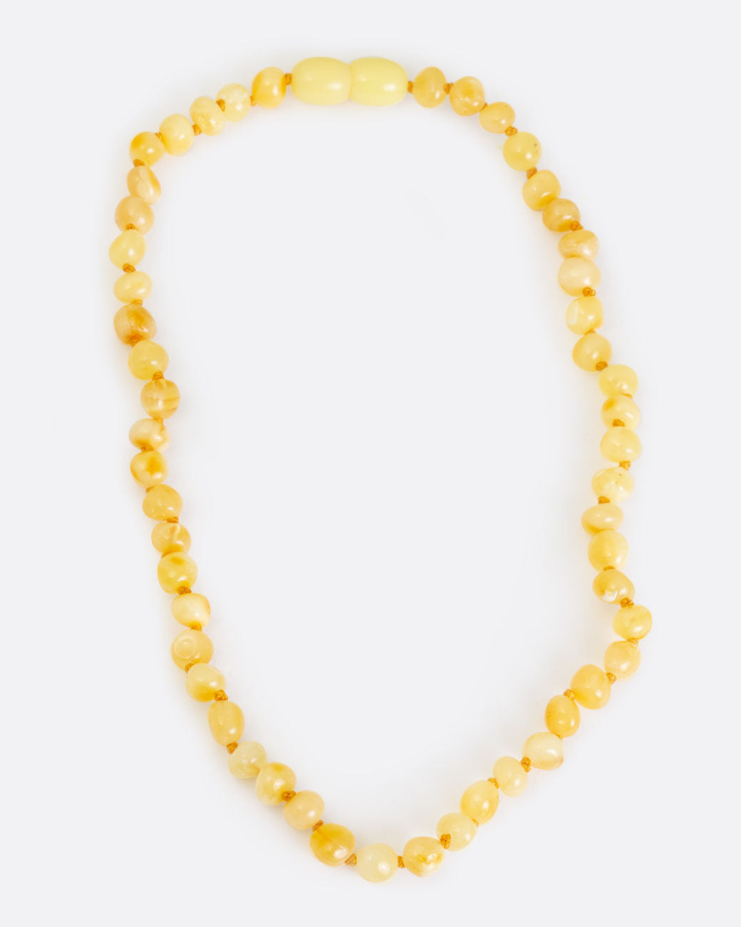 Yellow amber teething necklace, shown laying flat.