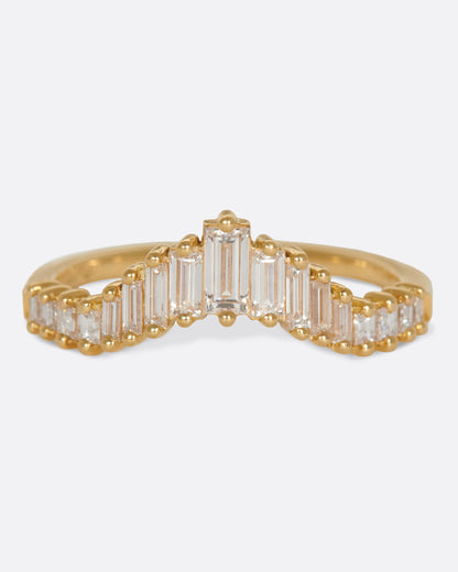 A curved crown ring lined with baguette diamonds. Shown from the front.
