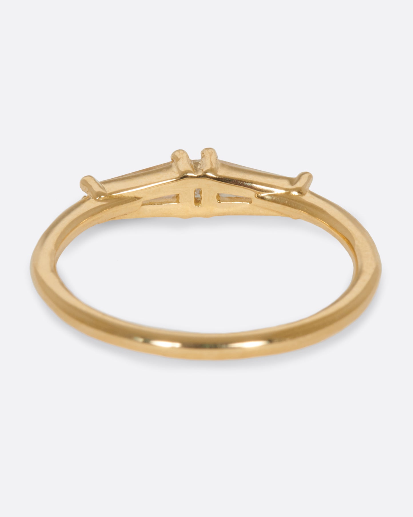 A ring featuring two tapered baguette diamonds and one carre cut diamond; perfect for stacking.