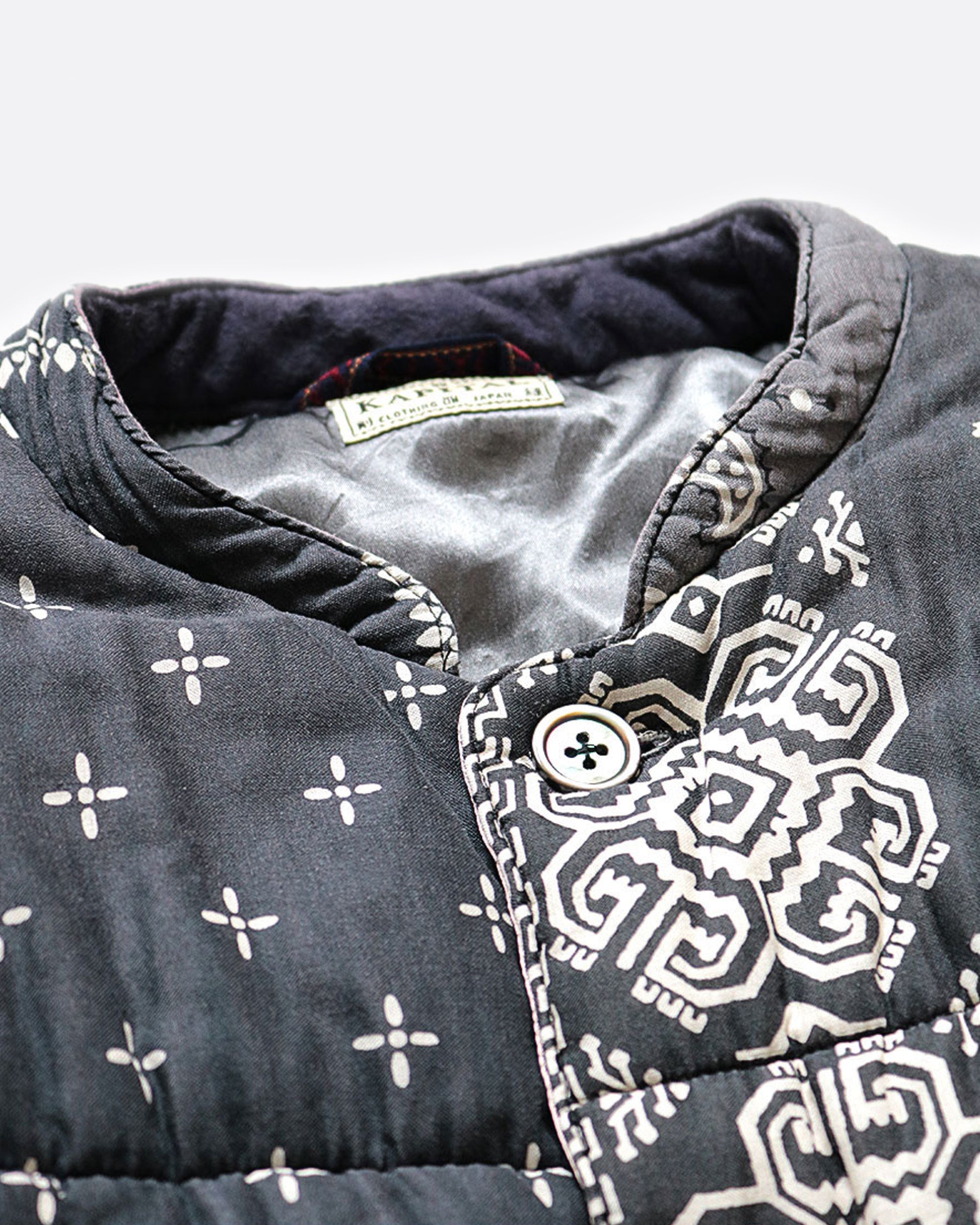 A close up of the collar on the black quilted patchwork bandana jacket.