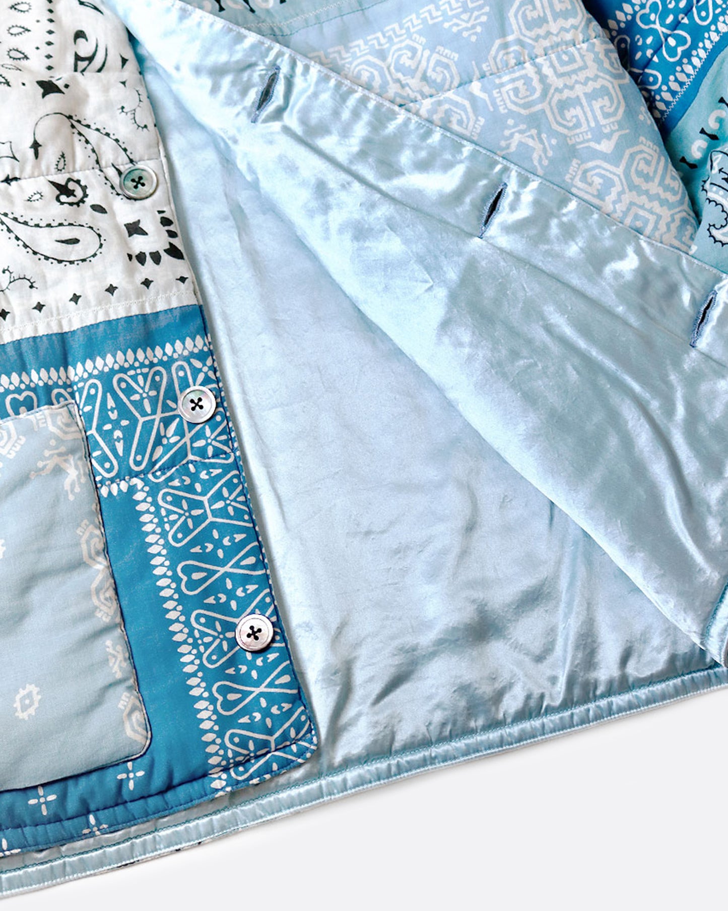 A close up of the lining on the light blue quilted patchwork bandana jacket.