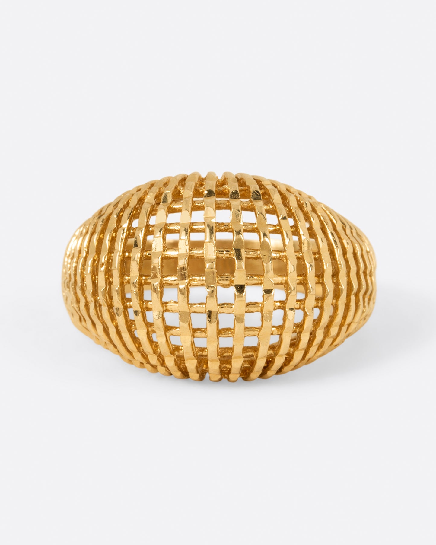 A woven yellow gold dome ring, shown from the front.