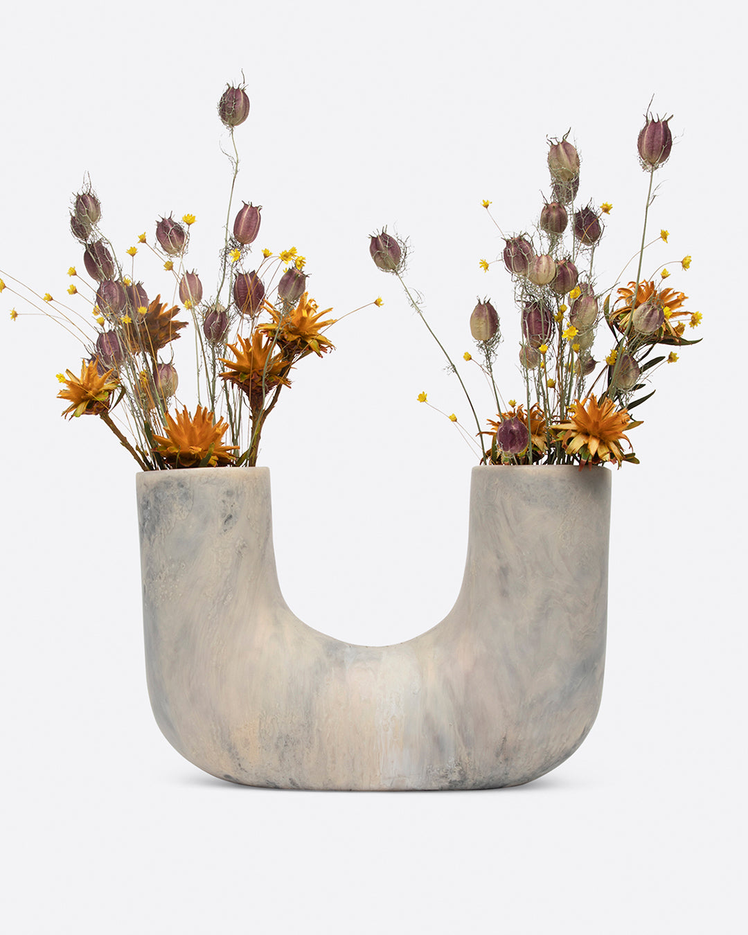 A swirled gray resin U-shaped vase with an opening on either side, shown from the front with dried flowers.