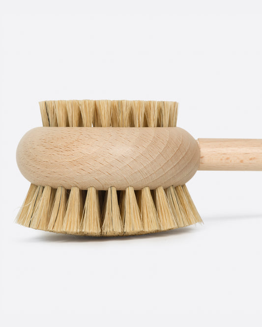 A round beechwood body brush with bristles on both sides, shown from the side.