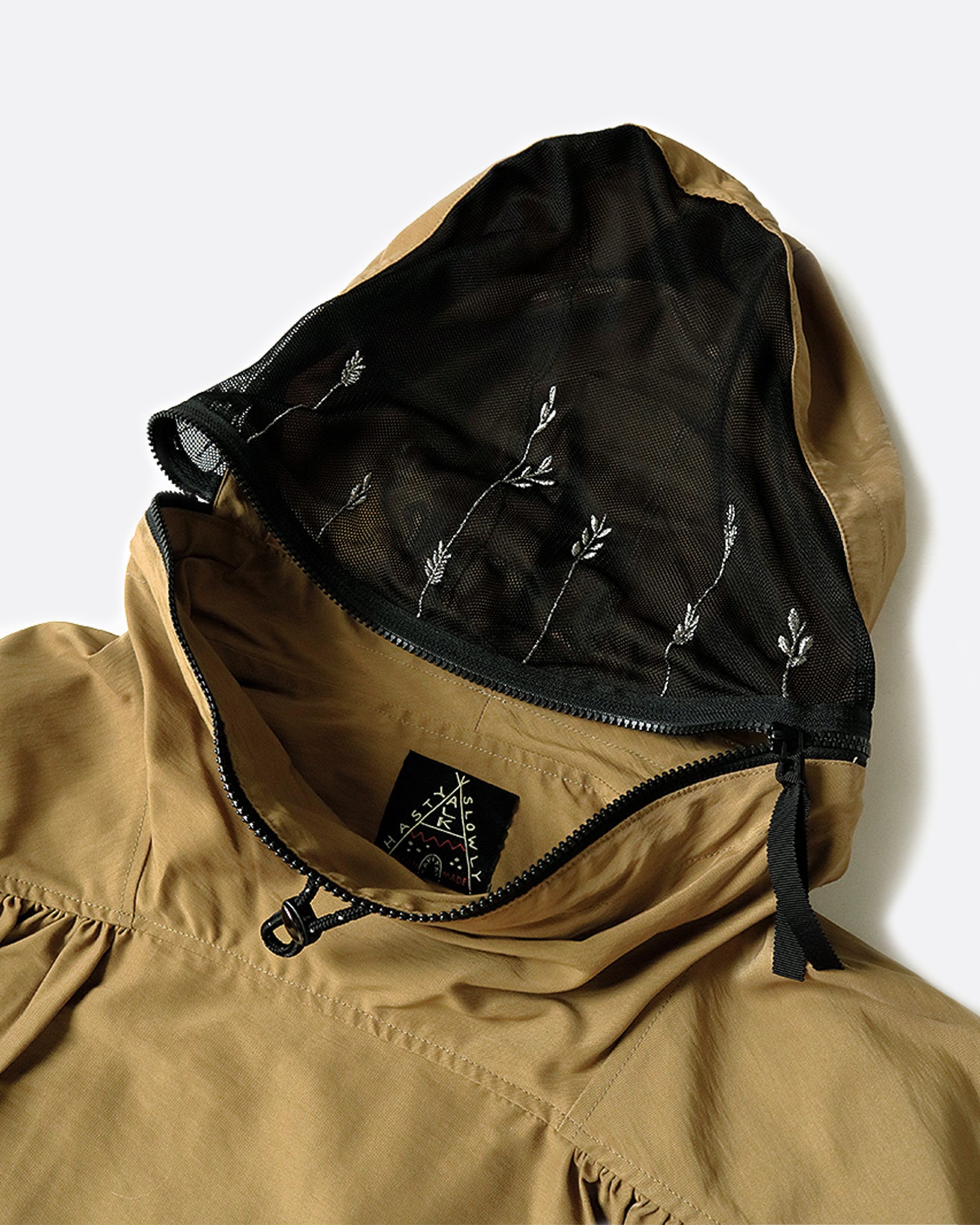 A 60/40 cloth pullover jacket with embroidered mesh panels on the front and back of the hood.