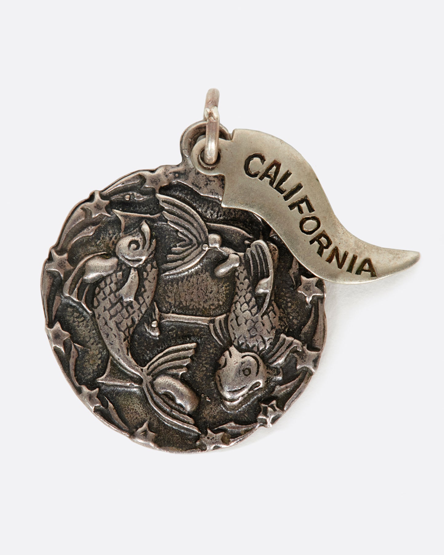 A round medal pendant with your zodiac sign and a California pennant.