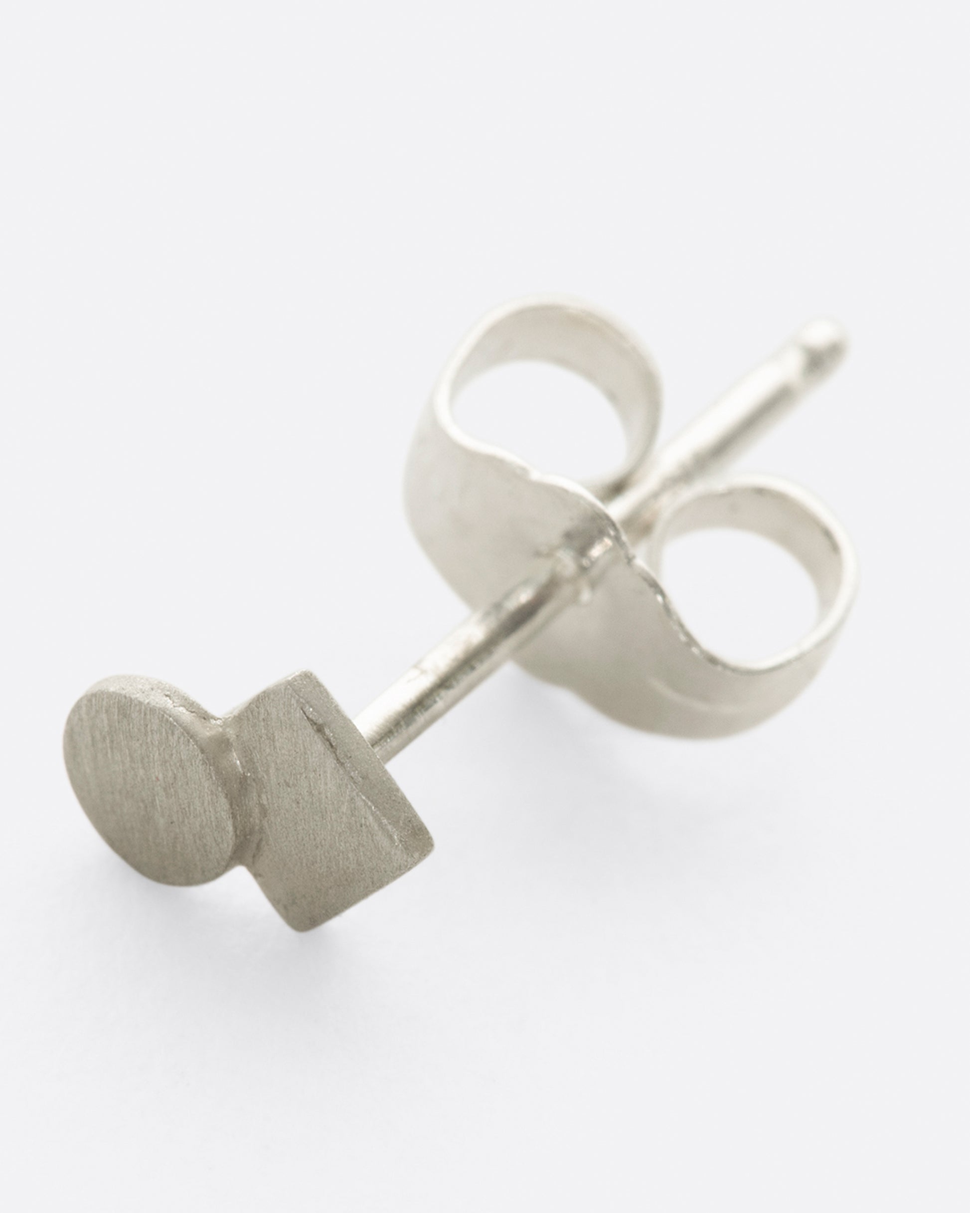 Sterling silver square stud earring with overlapping circle and matte finish.