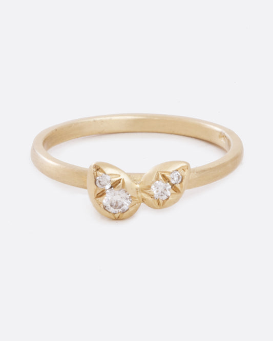 front view of simple 10k yellow gold band with four asymmetrical diamonds stacked in a central geometric cluster