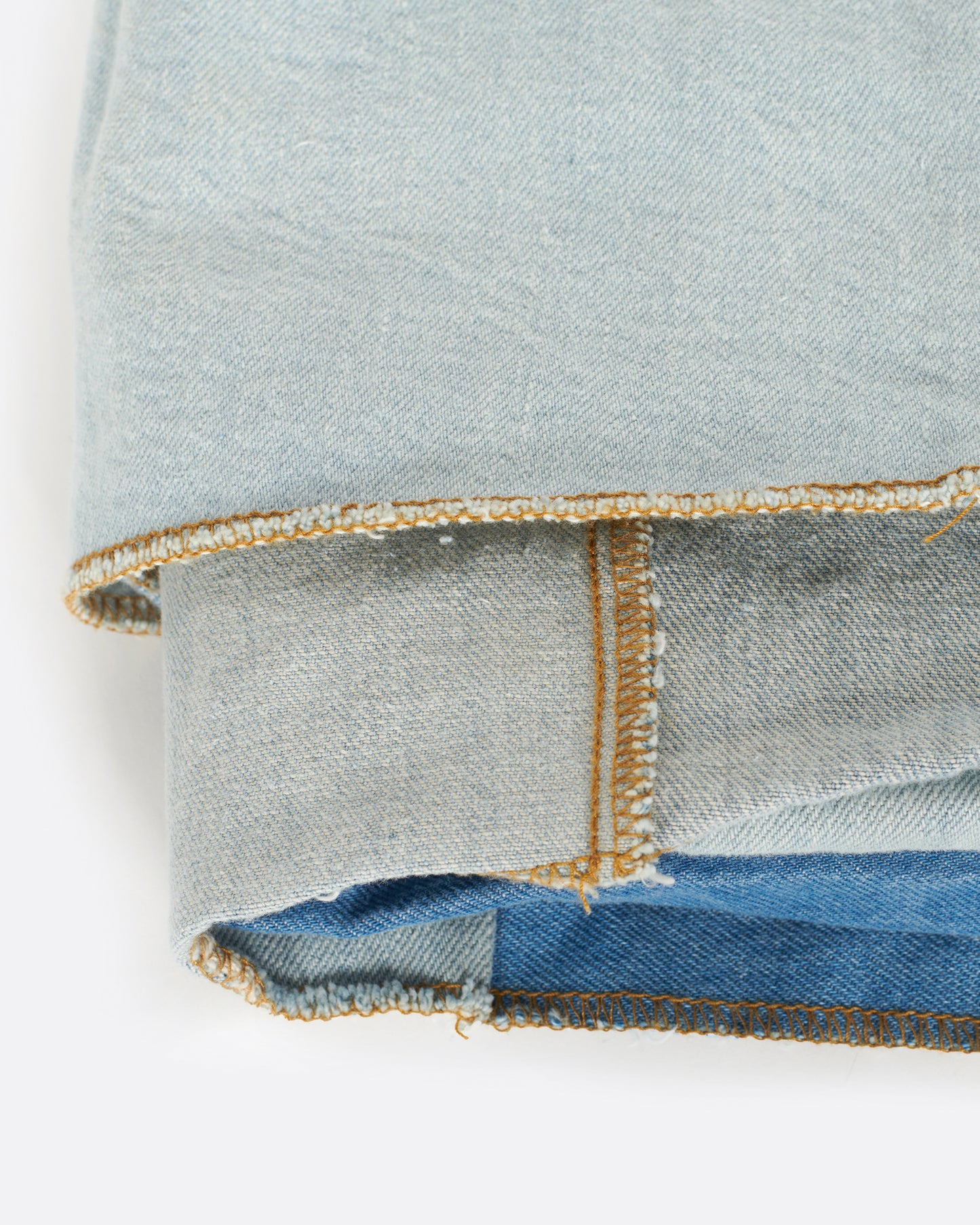 A handcrafted blanket made from pieces of dead stock denim, perfect for picnics.