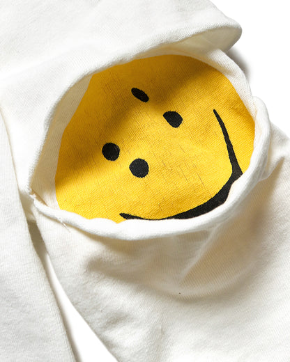 A close up of the elbow of a white long sleeve shirt with hidden yellow smileys peeking out at the elbows. 