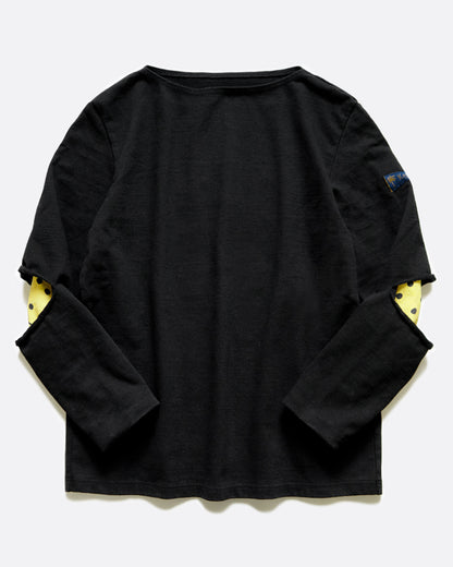 A black long sleeve shirt with hidden yellow smileys peeking out at the elbows. Shown from the front.
