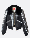 A hand painted black and white checked jacket with a faux fur collar and zip front. Shown from the front.