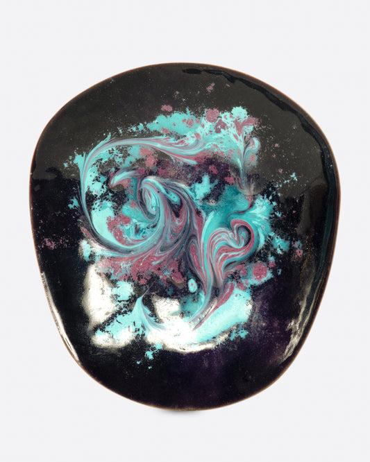 A metal dish, tapered at one side, coated in swirled pink and blue enamel.