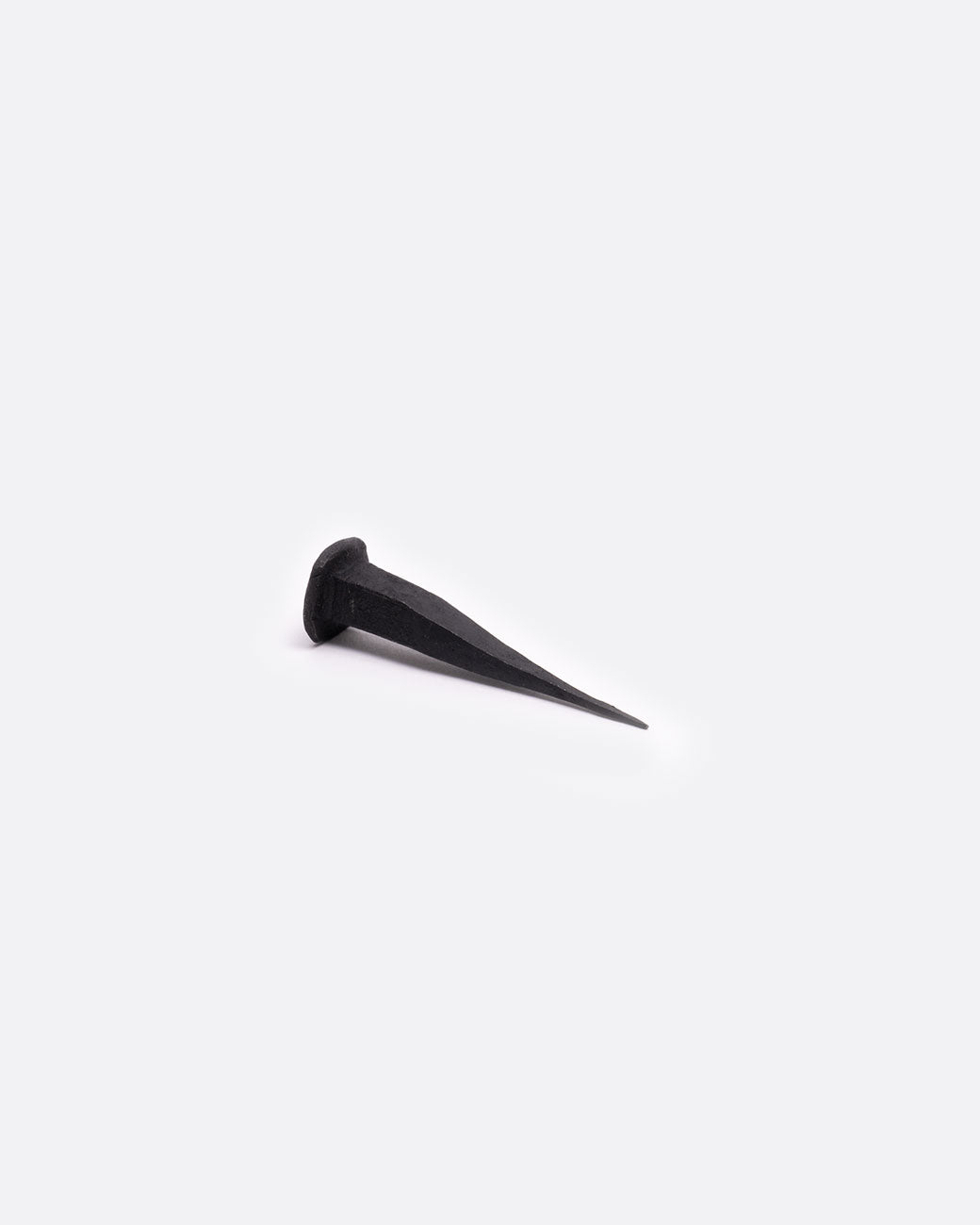 A single flat head iron nail.